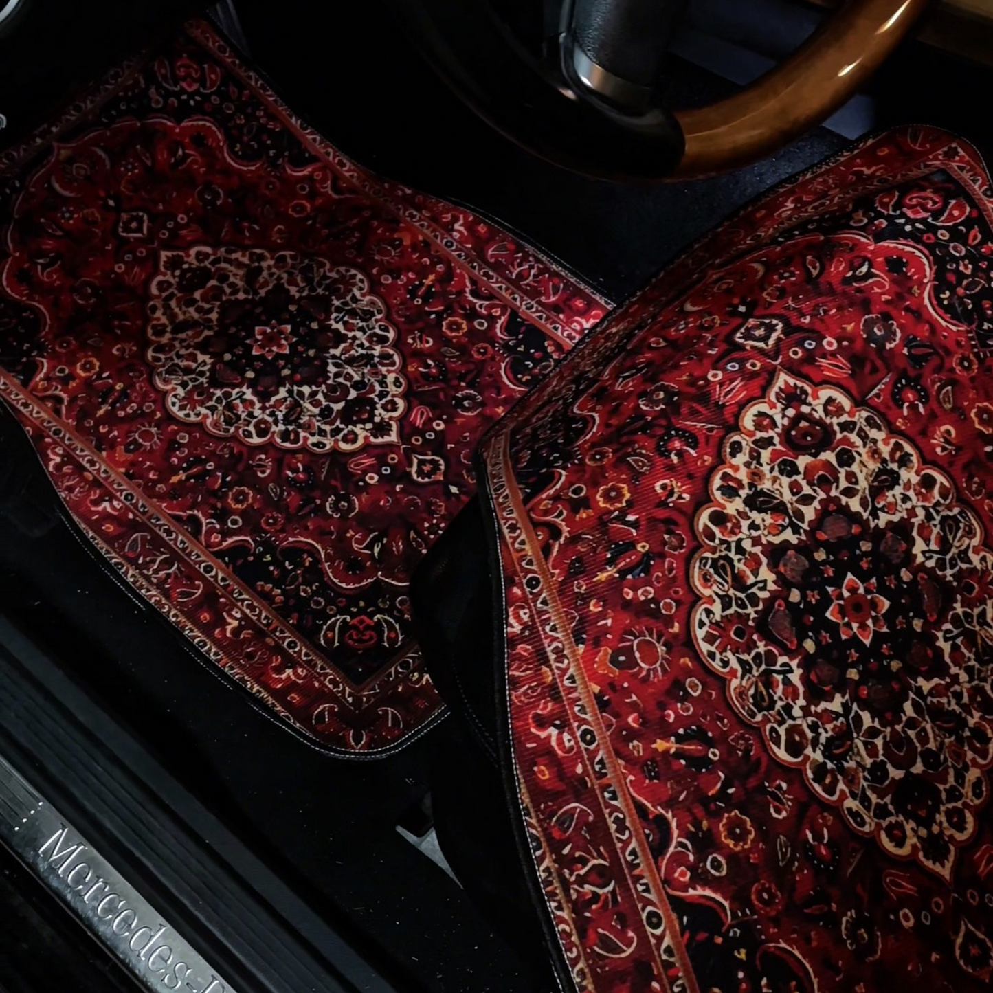 Decorative car mats with intricate patterns on a Mercedes-Benz vehicle.